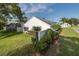 Exterior view of the home showcasing the lawn and manicured landscaping, and it's close to the street at 1084 Vista Fina Ct, Spring Hill, FL 34608