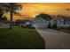 A bright single-Gathering home featuring manicured landscaping, a long brick driveway, and a two-car garage at 1084 Vista Fina Ct, Spring Hill, FL 34608