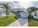 A bright single-Gathering home featuring manicured landscaping, a long brick driveway, and a two-car garage at 1084 Vista Fina Ct, Spring Hill, FL 34608