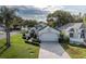 A bright single-Gathering home featuring manicured landscaping, a long brick driveway, and a two-car garage at 1084 Vista Fina Ct, Spring Hill, FL 34608