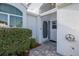 Charming front entrance with textured walls, a decorative door, and a well-maintained stone paver walkway at 1084 Vista Fina Ct, Spring Hill, FL 34608