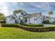 Beautiful single-Gathering home featuring manicured landscaping, a two-car garage, and a charming gated entrance at 1084 Vista Fina Ct, Spring Hill, FL 34608