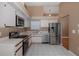 Updated kitchen with stainless steel appliances, white cabinets and tile floor at 1084 Vista Fina Ct, Spring Hill, FL 34608