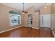 Open-concept living room with hardwood floors, large windows, and a ceiling fan provide a comfortable living space at 1084 Vista Fina Ct, Spring Hill, FL 34608