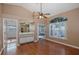 Open living room with hardwood floors, a ceiling fan, wet bar and seamless access to the screened in porch at 1084 Vista Fina Ct, Spring Hill, FL 34608
