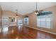 Expansive living room with hardwood floors, ceiling fans, and a wet bar with seamless access to the outdoors at 1084 Vista Fina Ct, Spring Hill, FL 34608