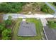 This aerial view showcases a well-maintained roof, lush lawn, and proximity to natural wooded areas at 11042 Heth Ct, Weeki Wachee, FL 34613