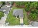 Aerial view of the house with manicured lawn surrounded by lush greenery at 11042 Heth Ct, Weeki Wachee, FL 34613
