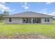 A well maintained backyard features a covered patio ideal for outdoor entertainment at 11042 Heth Ct, Weeki Wachee, FL 34613