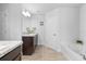 Spacious bathroom showcases a soaking tub, double sinks with granite countertops, and modern lighting at 11042 Heth Ct, Weeki Wachee, FL 34613