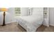Bright bedroom featuring a plush bed, bedside table with lamp, and built-in shelving at 11042 Heth Ct, Weeki Wachee, FL 34613
