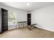 Carpeted room with fitness equipment, shelving, and a bright window at 11042 Heth Ct, Weeki Wachee, FL 34613