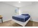 Bright bedroom featuring a white metal bed frame and a window with natural light at 11042 Heth Ct, Weeki Wachee, FL 34613