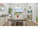 Cozy dining room with stone fireplace and large windows, perfect for Gathering gatherings and dinners at 11042 Heth Ct, Weeki Wachee, FL 34613