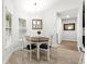 Cozy dining area features a round table, four chairs, pendant lighting, and wood-look floors at 11042 Heth Ct, Weeki Wachee, FL 34613