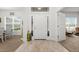 Bright foyer features wood-look tile, transom window, and views into the dining and living spaces at 11042 Heth Ct, Weeki Wachee, FL 34613