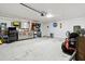 Well-lit garage featuring overhead door and ample space for storage and parking at 11042 Heth Ct, Weeki Wachee, FL 34613
