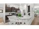 Modern kitchen showcases dark cabinets, stainless steel appliances, a breakfast bar, and granite countertops at 11042 Heth Ct, Weeki Wachee, FL 34613