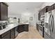 Bright open kitchen offers stainless appliances, tile backsplash, and wood floors at 11042 Heth Ct, Weeki Wachee, FL 34613