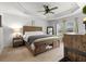 Spacious main bedroom with wood accents, tray ceiling, and large windows for natural light at 11042 Heth Ct, Weeki Wachee, FL 34613