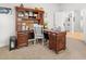 Office with large desk and chair with built-in cabinets to the left of the frame, and the office is bright at 11042 Heth Ct, Weeki Wachee, FL 34613