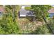 An aerial view of the house and the surrounding mature landscaping at 11340 Corinthian St, Spring Hill, FL 34609