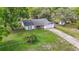 Aerial view featuring the home's lot, driveway, and backyard with surrounding foliage at 11340 Corinthian St, Spring Hill, FL 34609