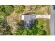 Bird's eye view of the home showcasing its layout and surrounding trees at 11340 Corinthian St, Spring Hill, FL 34609