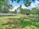 A full view of the spacious backyard with lush grass and mature trees at 11340 Corinthian St, Spring Hill, FL 34609