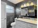 Modern bathroom features a white vanity with granite countertop and decorative tile accents at 11340 Corinthian St, Spring Hill, FL 34609