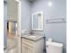 This bathroom features gray walls, white fixtures, and granite countertops at 11340 Corinthian St, Spring Hill, FL 34609