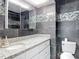 Stylish bathroom with modern fixtures, a granite countertop, and decorative tiled accents at 11340 Corinthian St, Spring Hill, FL 34609