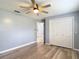 This bedroom features laminate flooring, a ceiling fan, and a closet with bi-fold doors at 11340 Corinthian St, Spring Hill, FL 34609