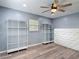 Bedroom showcases ceiling fan, wood-look flooring, shelving, and two white storage units at 11340 Corinthian St, Spring Hill, FL 34609