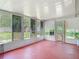 The enclosed Porch with sliding windows overlooks the large grassy back yard and access to doggie door at 11340 Corinthian St, Spring Hill, FL 34609