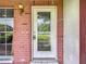 Elegant front door with decorative glass detailing set within a brick facade at 11340 Corinthian St, Spring Hill, FL 34609