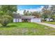 Charming single-story home with a well-manicured lawn and a two-car garage and brick features at 11340 Corinthian St, Spring Hill, FL 34609
