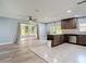 Open kitchen with granite countertops, stainless steel appliances, and access to outdoor patio at 11340 Corinthian St, Spring Hill, FL 34609