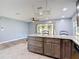 Spacious kitchen island features granite countertops and abundant storage space, with an adjacent dining area at 11340 Corinthian St, Spring Hill, FL 34609
