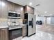 Well-equipped kitchen boasts stainless steel appliances, granite countertops, and ample cabinet space at 11340 Corinthian St, Spring Hill, FL 34609