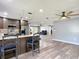 Open floor plan connecting the kitchen with seating to living area, fostering a welcoming and inclusive atmosphere at 11340 Corinthian St, Spring Hill, FL 34609
