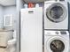 This laundry room features a stacked washer and dryer, freezer and a granite countertop at 11340 Corinthian St, Spring Hill, FL 34609