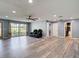Bright living room featuring wood-look floors, neutral color scheme, and comfortable seating at 11340 Corinthian St, Spring Hill, FL 34609