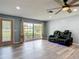 Bright living room with wood-look floors, large window, and comfortable seating at 11340 Corinthian St, Spring Hill, FL 34609