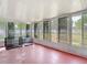 This sunroom features a view to the back yard and a pet kennel at 11340 Corinthian St, Spring Hill, FL 34609