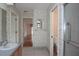 Full bathroom with floral wallpaper, single sink, and separate room with toilet and shower at 11364 Orangewood Ct, Spring Hill, FL 34609