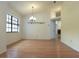 Open-concept dining room featuring wood floors and a large window allowing natural light at 11364 Orangewood Ct, Spring Hill, FL 34609