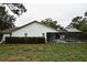 Exterior view of home with screen enclosed pool and sparse landscaping at 11364 Orangewood Ct, Spring Hill, FL 34609