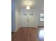 Bright foyer featuring wood floors, double front doors and a hanging light fixture at 11364 Orangewood Ct, Spring Hill, FL 34609