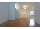 Bright foyer featuring wood floors, double front doors and a hanging light fixture at 11364 Orangewood Ct, Spring Hill, FL 34609